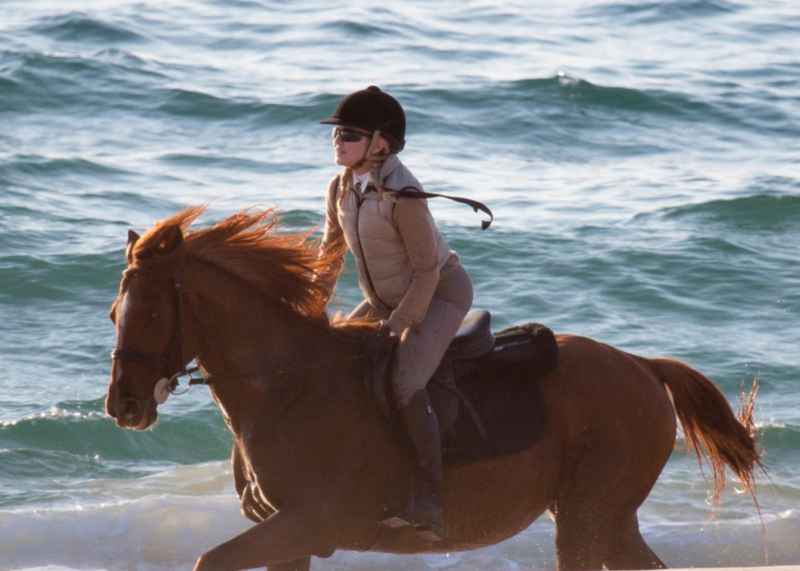 Horseback riding on a beach in Portugal with Madonna