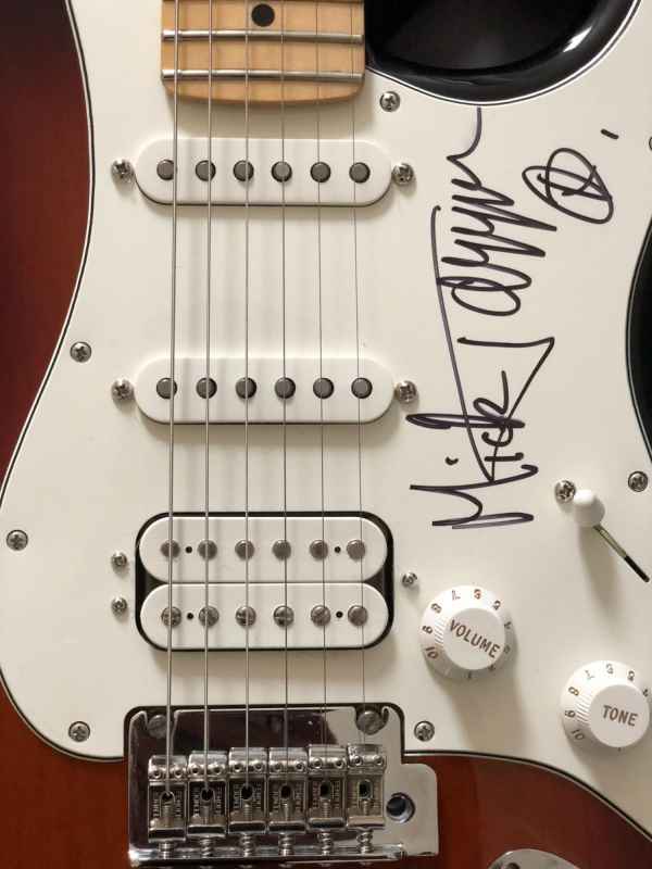 a guitar signed by Mick Jagger